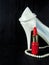 Glamorous composition made of white heels, red lipstick and pearl necklace