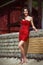 Glamorous curvy brunette in red stone dress with body