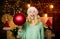 Glamorous decorations. Christmas decorations. Love to decorate everything around. Girl santa claus hold ball to decorate