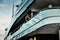 A glamorous diva in an evening dress of black color and sunglasses stands on the top deck of a huge yacht in