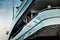 A glamorous diva in an evening dress of black color and sunglasses stands on the top deck of a huge yacht in