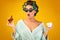 Glamorous Housewife With Curlers Having Coffee And Croissants, Yellow Background