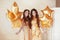 Glamorous ladies party, two women in fashion golden dresses with