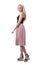 Glamour feminine blonde young woman in pink pleated skirt walking and looking down.