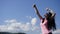 Glamour girl in the mountains makes selfi on the blue sky background