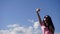 Glamour girl in the mountains makes selfi on the blue sky background