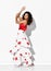 Glamour gorgeous smiling woman model hispanic dancer wearing red white gown with flower print dancing