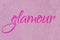 Glamour lettering word neon pink on light pink ballet slipper glitter texture. Shiny sparkle background
