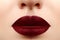 Glamour lips with sensuality gesture. Dark Red Lipstick, clean skin. Velvet mat Makeup. Augmentation with Filler