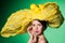 Glamour portrait closeup of a young woman in yellow hat.