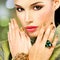 Glamour woman with beautiful golden nails and emerald ring