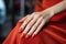 Glamour woman hand with classic red nail polish on her fingernails. Red nail manicure with gel polish at luxury beauty salon. Nail