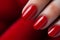 Glamour woman hand with classic red nail polish on her fingernails. Red nail manicure with gel polish at luxury beauty salon. Nail