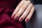 Glamour woman hand with classic red nail polish on her fingernails. Red nail manicure with gel polish at luxury beauty salon. Nail