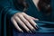 Glamour woman hand with dark blue nail polish on her fingernails. Black nail manicure with gel polish at luxury beauty salon.