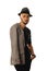 Glamour young unshaved man in hat and jacket looking at the came