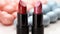 Glamourous women showcase elegance with vibrant lipstick and nail polish generated by AI