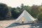 Glamping campsite in the forest. Big camping tent for luxury outdoor vacation. Staycations, hyper-local travel, night camping out