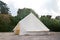 Glamping campsite in the forest. Big camping tent for luxury outdoor vacation. Staycations, hyper-local travel, night camping out