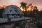 Glamping Geodesic Dome luxury tent amid cactus at sunset