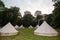 Glamping teepees in a circle in a field
