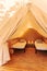 Glamping tent, luxury and cozy interior with beds on a sunny day. Glamorous camping tent for outdoor summer holiday and vacation