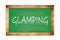 GLAMPING text written on green school board