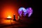 In the glare of a burning candle, a chess piece pawn gives a wedding ring to the Queen. Abstract image of love in the bypass of