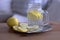 Glas of lemon juice on a old wooden table. Healthy detox drink with lemon.Blurred background.Food concept. Styled stock