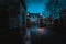 GLASGOW, SCOTLAND, DECEMBER 16, 2018: Spooky cobbled street surrounded by old European style buildings. Illuminated only with weak