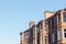 Glasgow street photography: brick buildings against the blue sky