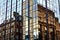 Glasgow tenements reflected in the windows of modern buildings.