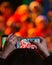 Glasgow, UK: 14th December 2018 - Parent recording their children during a nativity play at Christmas time in one of the primary