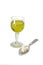 Glass with absinth and spoon with sugar pieces