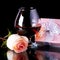 Glass with alcohol and rose and gift box