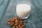 Glass Of Almond Milk On Blue Wooden Background With Almond Nuts