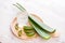 Glass of aloe vera juice with fresh leaves on a wooden table