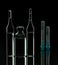 Glass ampoules close up. Medical ampoules. Medical ampoules, syringe needles on a black background