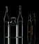 Glass ampoules with liquid on a black background in backlight. Medical items. Virus, bacteria, infection. Prevention and treatment
