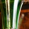 Glass antique green vase in luxury interior. crystal vase with gold painting close-up.