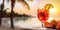 Glass of aperol spritz cocktail on wooden table in open air cafe with blurred beach on background, sunset.