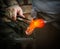 Glass Artist in her workshop making glassware