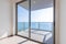 The glass balcony overlooks the sea.