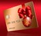 A glass ball Christmas ornament and a red ribbon and bow decorate a generic mock holiday credit card i