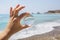 Glass ball in hand. Sea landscape