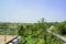 Glass-balustraed roof terrace of roadside uptown building in sun