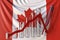 Glass bar chart with downward trend against flag of Canada. Financial crisis or economic meltdown related conceptual 3D