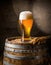 glass of beer on a barrel in a dark room