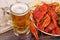 Glass of beer and a boiled crawfishes in a plate