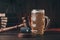 Glass of beer, car keys and wooden gavel. Drinking and driving problem